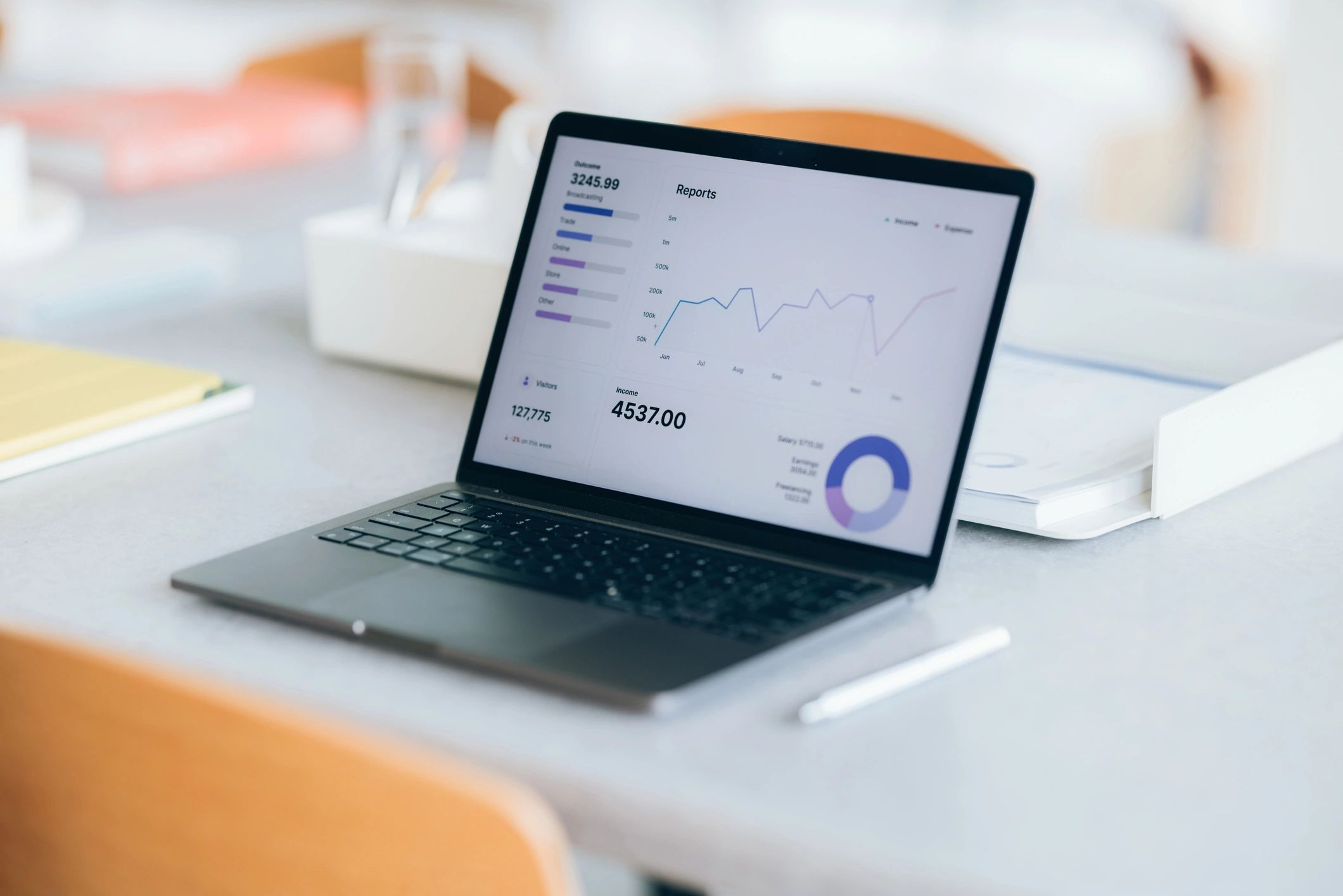 Laptop displaying growth charts and analytics on a modern desk